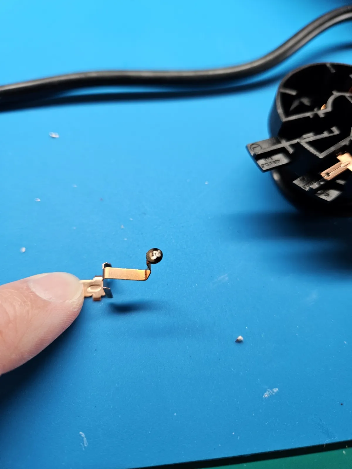 A spring contact removed from the kettle connector for cleaning